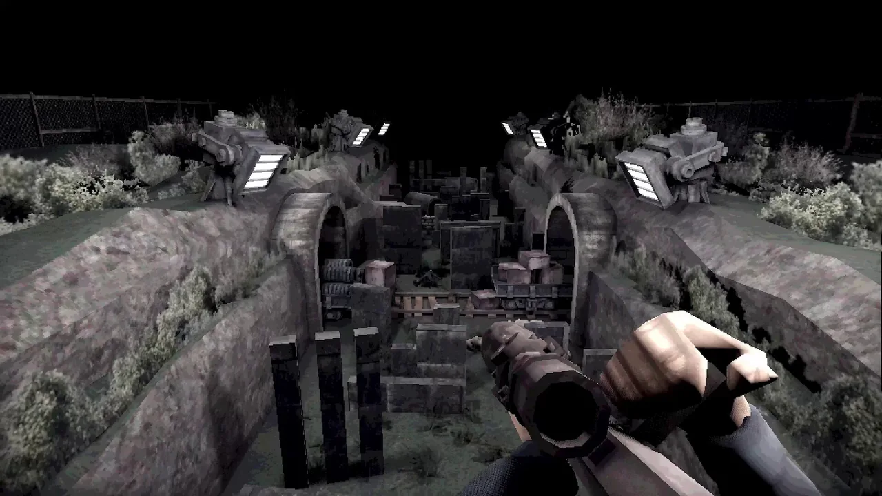 First-person view down a floodlit trench full of arches and crates, rifle raised